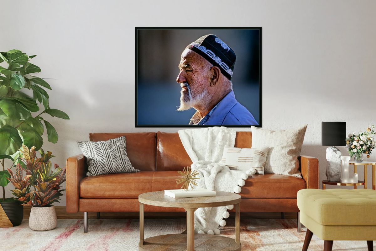 Elderly man in traditional clothing walks in Khiva Uzbekistan
