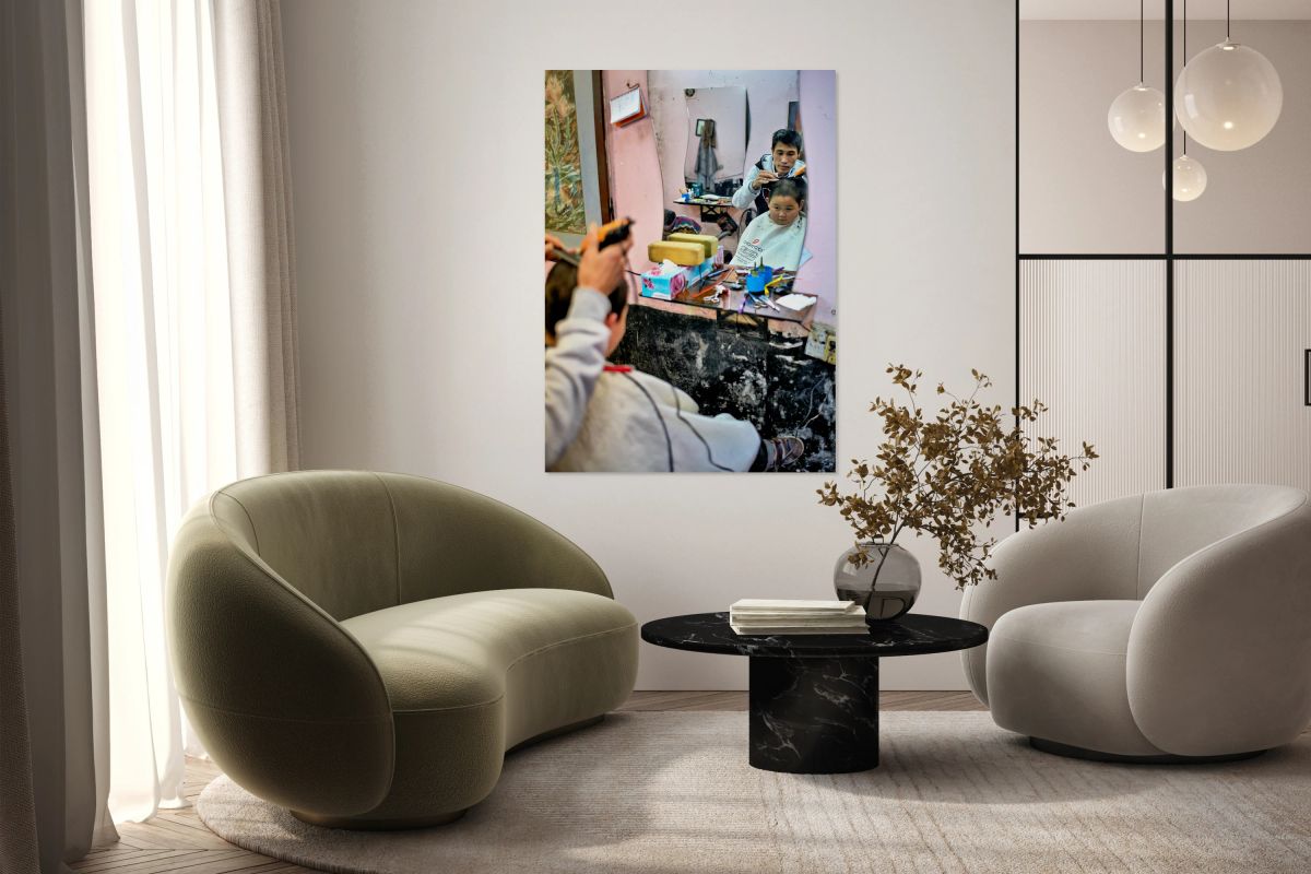 Young boy gets a haircut in a Hanoi barbershop