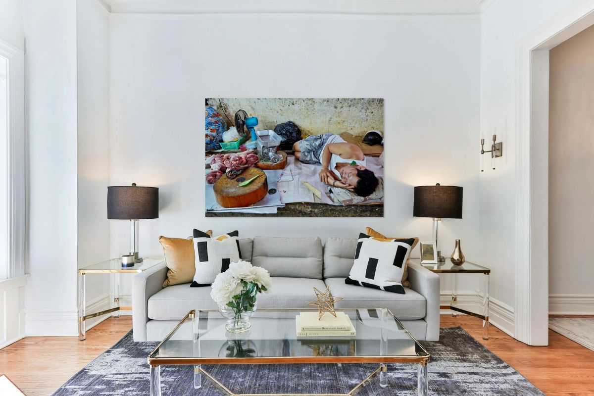 Man resting by meat stall in Ho Chi Minh City