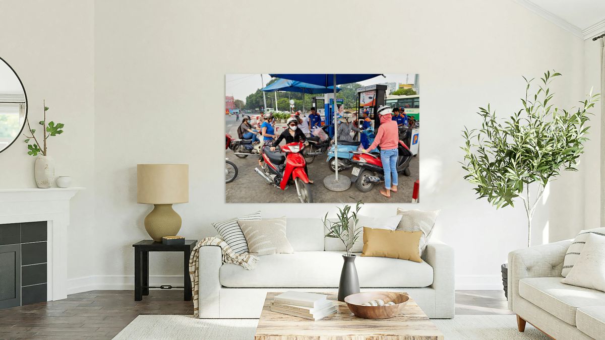 People refueling motorbikes at a gas station in Ho Chi Minh City