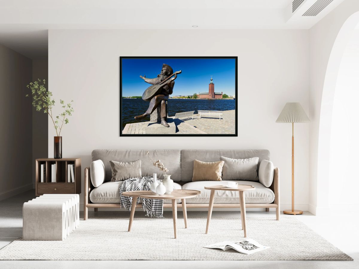 Evert Taube statue and City Hall by the water in Stockholm