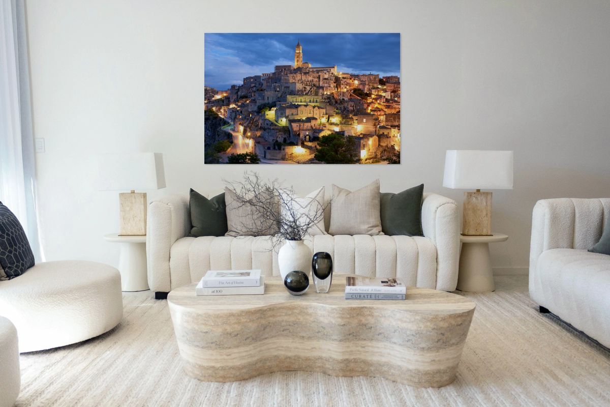 Cityscape of Matera at dusk with lights glowing