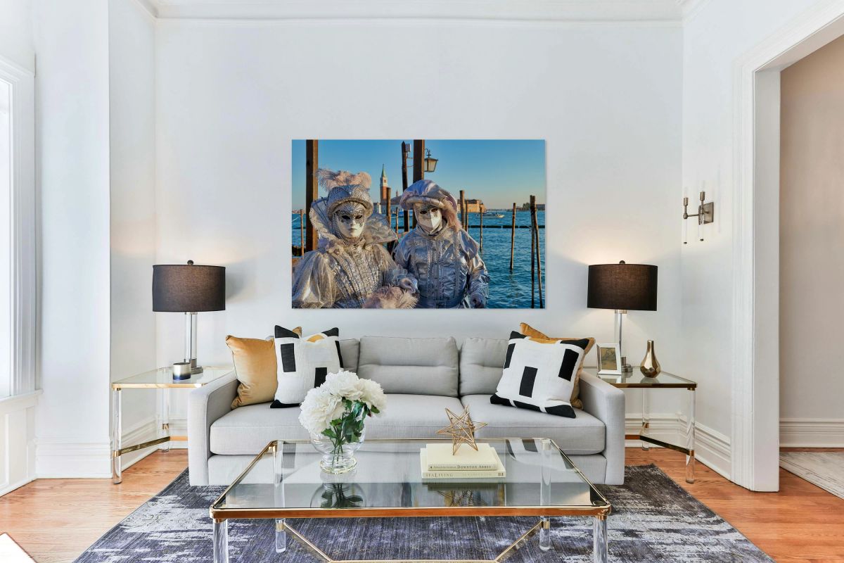 Venice Carnival with silver costumes near water