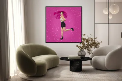 Smiling female model dancing in falling rain Reproduction