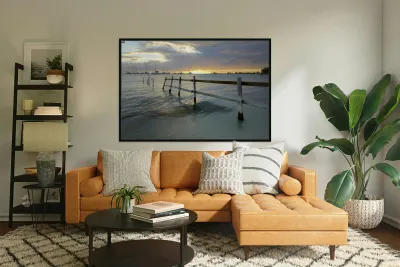 Old fence running into the ocean Reproduction