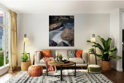 Pebbles balanced on rocks in raging river illustrating resilienc Reproduction