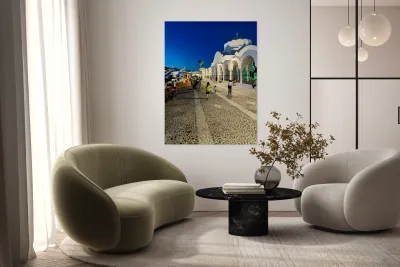 Santorinis iconic white church and bustling street at dusk. Reproduction