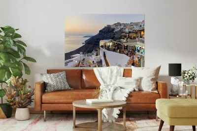 Santorini cliffside town with restaurants and people enjoying th Reproduction