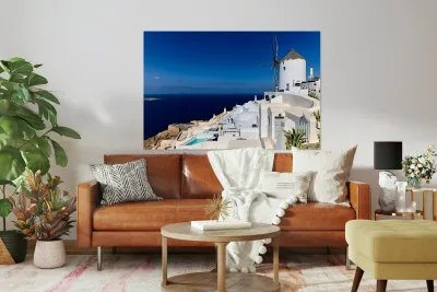 Santorinis iconic white architecture and windmill against the d Reproduction