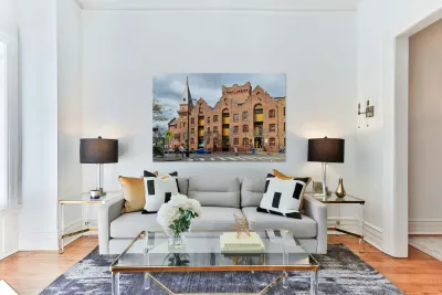 Historic brick building with a tower and people walking. Reproduction
