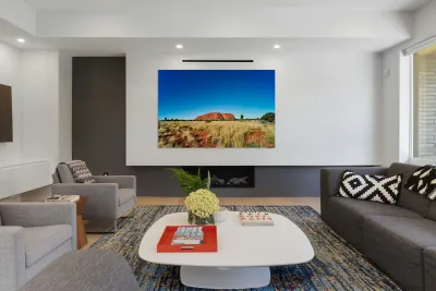 Uluru Australias iconic sandstone monolith under a clear blue Reproduction