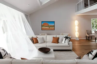 Vast red rock formation under a clear blue sky. Reproduction