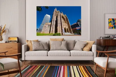 Historic church stands tall next to modern skyscrapers. Reproduction