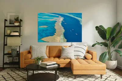 Aerial view of coral reefs and boats in turquoise ocean. Reproduction