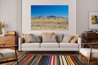 Granite peaks of Spizkoppe rise in Namib Desert landscape Reproduction