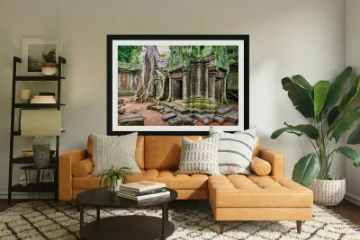 Ancient temple ruins overgrown by massive tree roots and moss. Reproduction