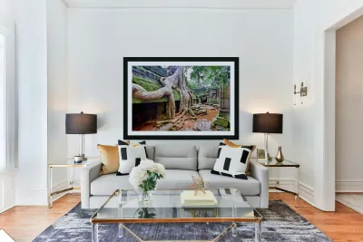 Massive tree roots engulfing ancient moss covered temple ruins. Reproduction