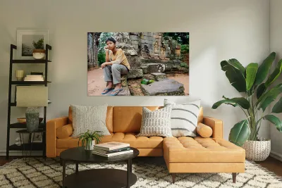 Young person sits on ancient temple ruins. Reproduction