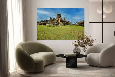 Angkor Wat temple complex with green grass and blue sky. Reproduction