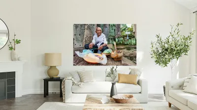 Elderly person selling goods at ancient temple ruins. Reproduction