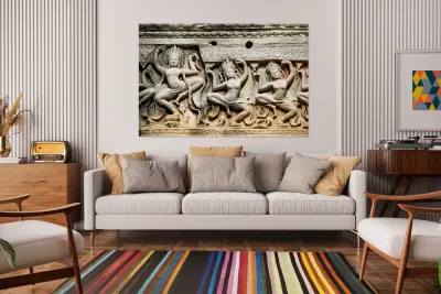 Ancient stone carvings of dancing Apsaras on a temple wall. Reproduction