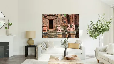 Ancient Cambodian temple with intricate red sandstone carvings a Reproduction