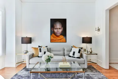 Young Buddhist monk in orange robe close up portrait. Reproduction