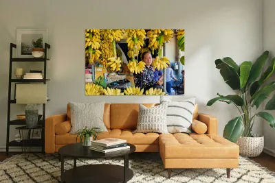 Market vendor surrounded by abundant yellow bananas. Reproduction