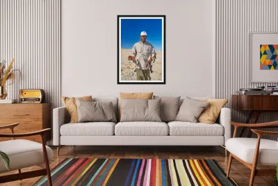 Shepherd holds his young goats in Namibia under bright blue sky Reproduction