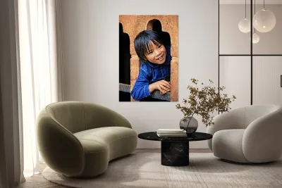 Smiling child peeking from a wooden window. Reproduction