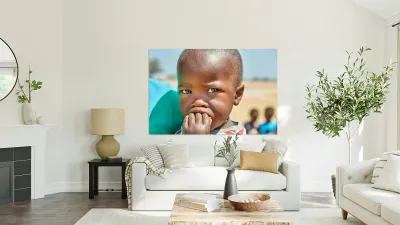 Sad boy in Kavango Region of Namibia looks thoughtful and lost Reproduction