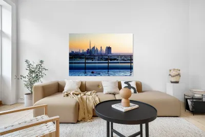 Swimming in infinity pool overlooking Dubai skyline at sunset Reproduction