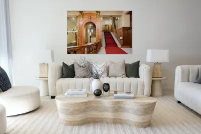 Elegant interior with red carpeted staircase and ornate gold det Reproduction