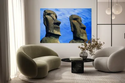 Two Moai statues against a blue sky. Reproduction