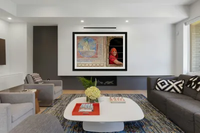 Woman smiles while looking out of a window in Mandawa Rajasthan Reproduction