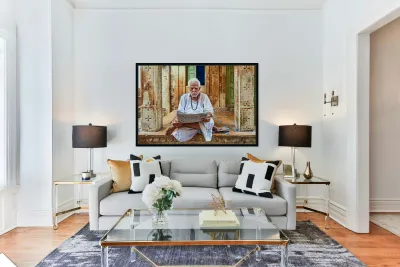 Man reads newspaper on street in Jaisalmer Rajasthan India Reproduction