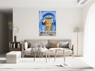 Goat standing on a wall by a wooden door in Bundi Rajasthan Reproduction