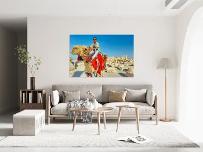 Camel driver in ancient Palmyra leading a tourist ride Reproduction