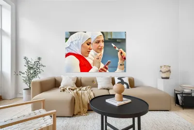 Young women enjoy hookah and talk on mobile phone in Aleppo Syri Reproduction