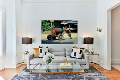 Boy pushes a cart down the street in Myanmar during the day Reproduction