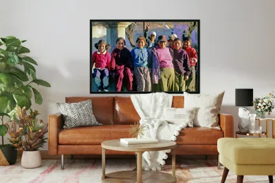 Smiling children and youth gather by a fountain. Reproduction