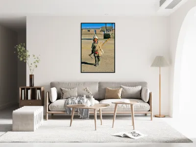 Indigenous boy with tools walks through a dusty village. Reproduction