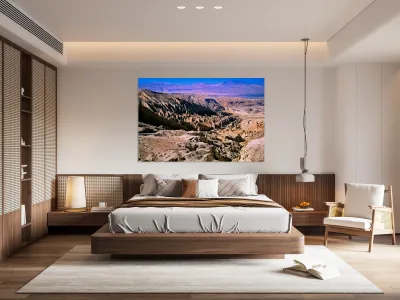 Eroded desert landscape with a road winding through mountains. Reproduction