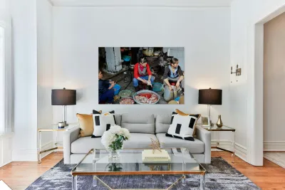Women preparing fish in a market in Hanoi Vietnam Reproduction
