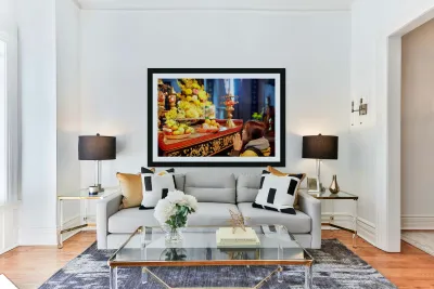 Person offers prayers at altar with fruits in Ho Chi Minh Reproduction