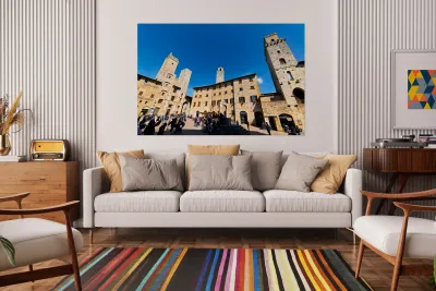 Visitors walk through Piazza della Cisterna in San Gimignano Reproduction