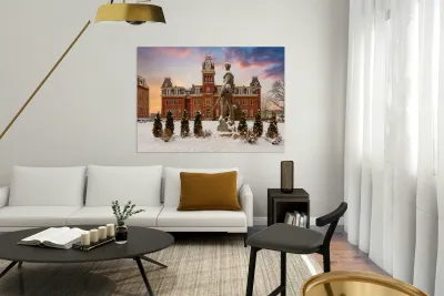 Mountaineer statue against Woodburn Hall Reproduction