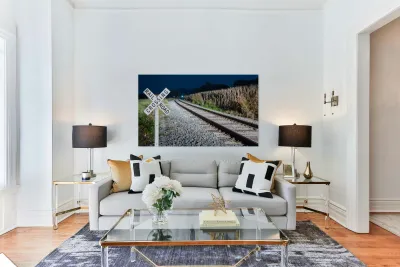 Oncoming train with railroad crossing sign Reproduction