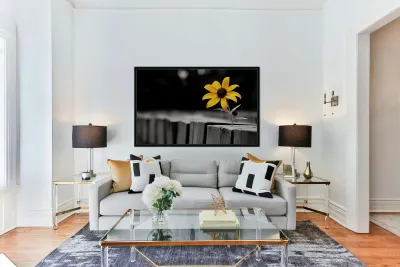 Defiant Bloom – Yellow Flower on Fence Print Reproduction